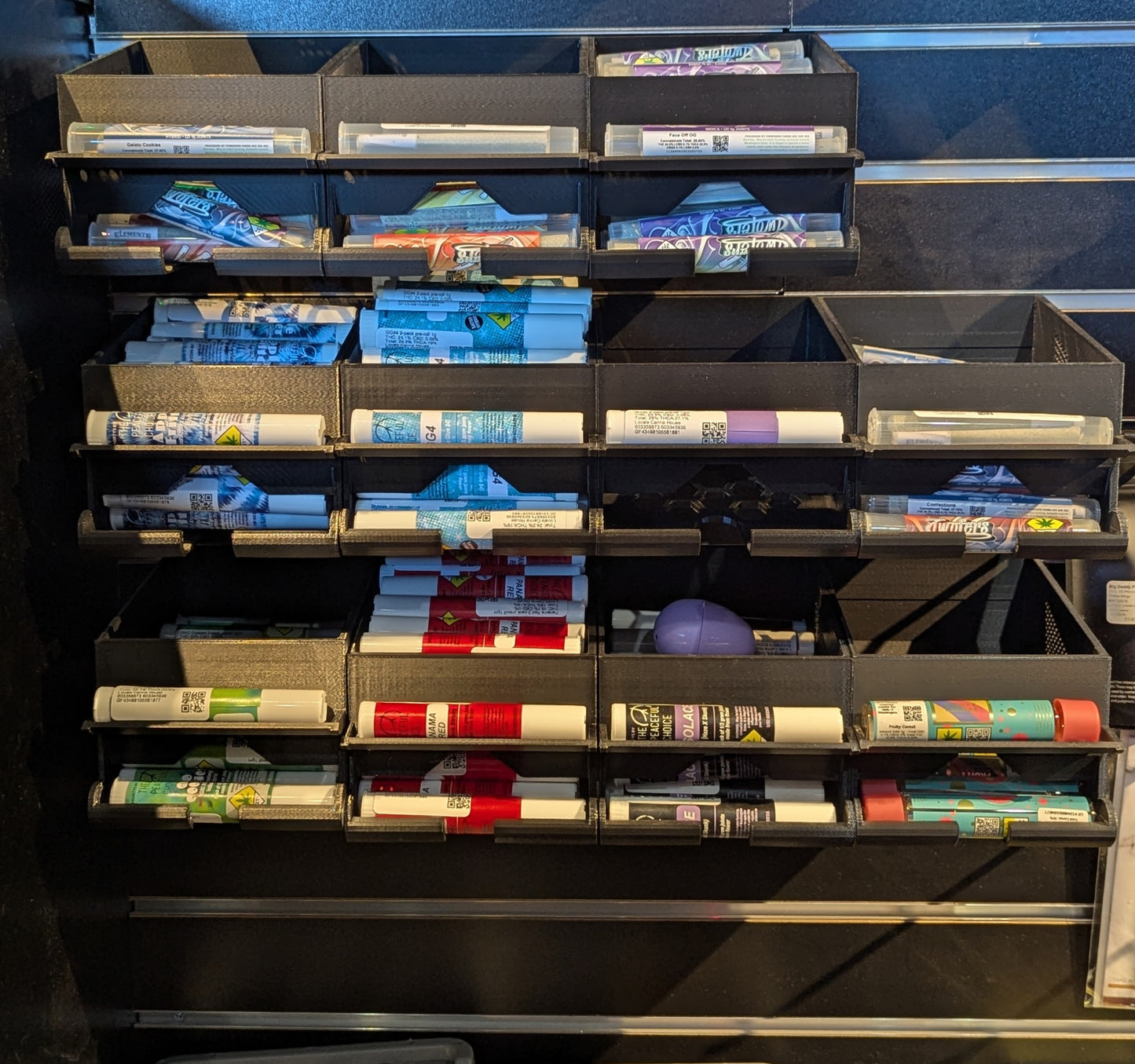 Weiter slatwall display holding 11 cannabis pre-rolls with space for up to 16 products across 8 rows