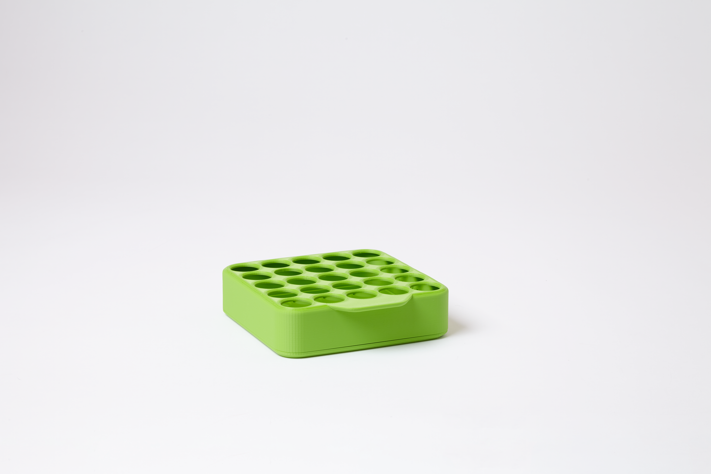 Empty rainforest green grid display for 22mm pre-roll tubes, holds 25 tubes in 5 rows